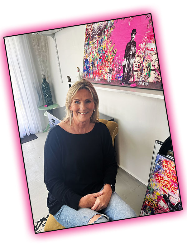 Furniture Sales Lady sitting in her Shop smiling