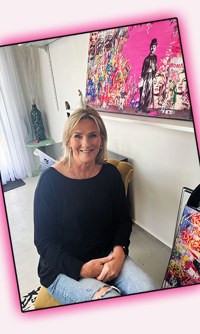 Furniture Sales Lady sitting in her Shop smiling