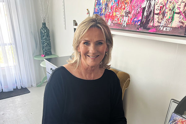 Sales Lady sitting in her Shop smiling